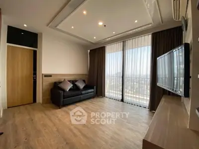 Spacious modern living room with large windows and wooden flooring