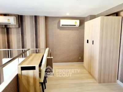 Modern interior with stylish wooden furniture and air conditioning in a cozy living space.