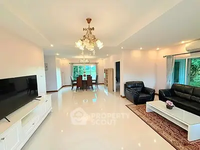 Spacious living room with elegant chandelier and modern furnishings