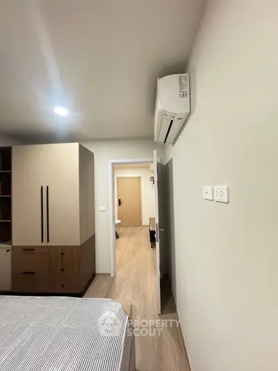Modern bedroom with air conditioning and stylish storage solutions
