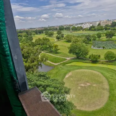 Scenic view of lush green golf course from a high vantage point, perfect for golf enthusiasts.
