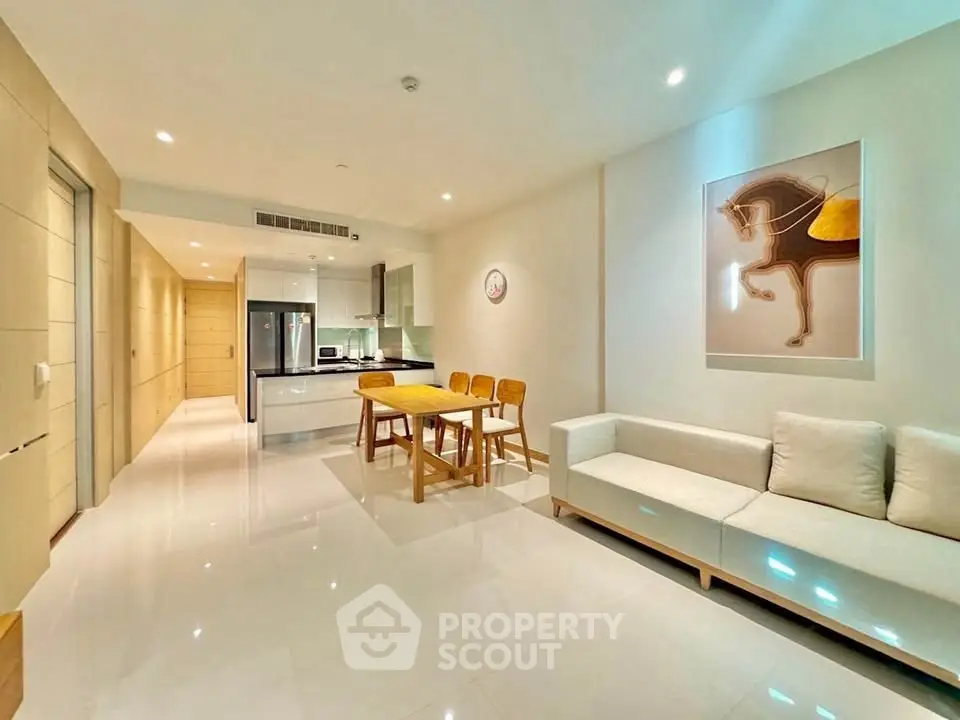 Modern open-plan living room with sleek kitchen and stylish decor