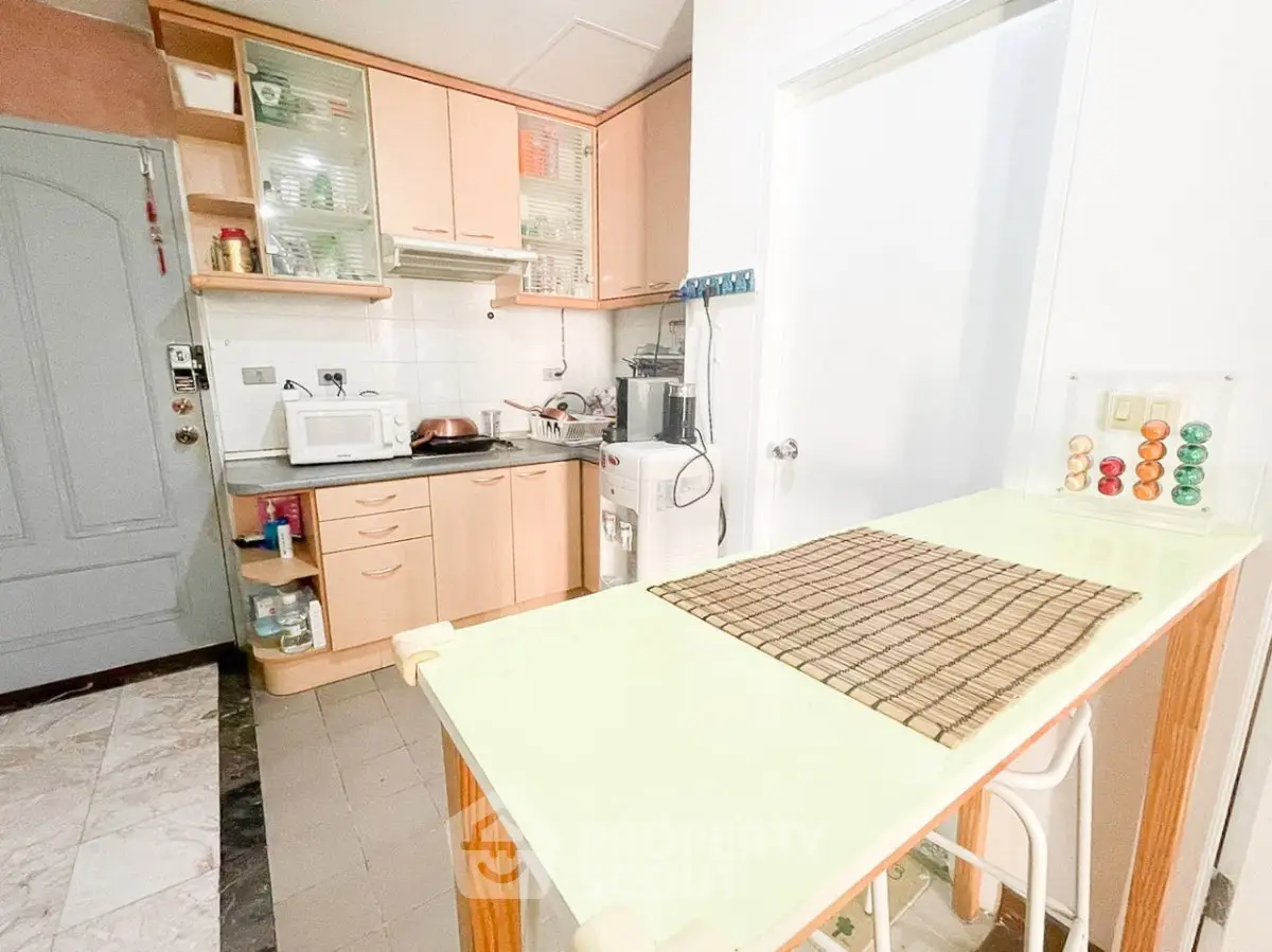 Charming kitchen with closed layout and modern appliances in cozy apartment.