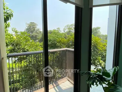 Charming balcony view with lush greenery, perfect for relaxation and nature lovers.