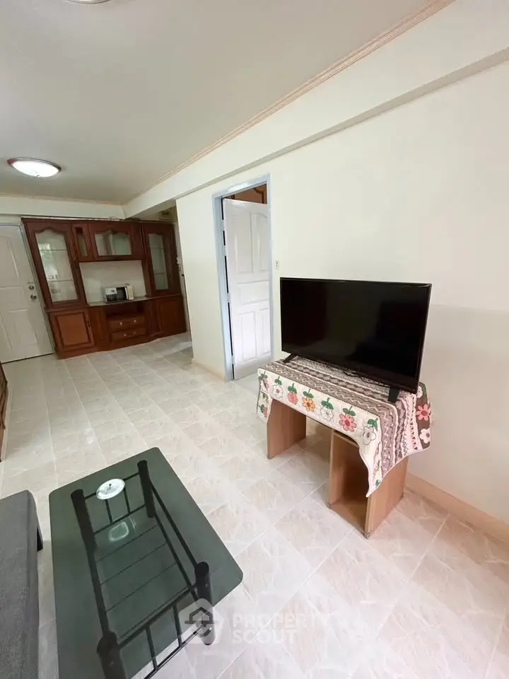 Spacious living room with modern TV and elegant furniture