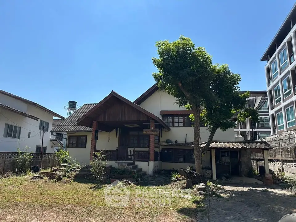 Charming traditional house with spacious yard and lush greenery, perfect for serene living.