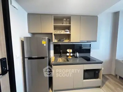 Modern kitchen with sleek cabinetry and built-in appliances in a compact layout.