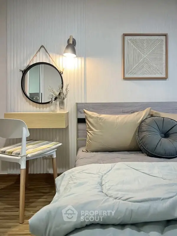 Cozy bedroom with modern decor, featuring a stylish mirror, wall art, and comfortable bedding.