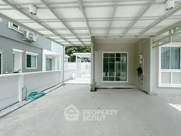 Spacious covered parking area in modern residential property with clean design.