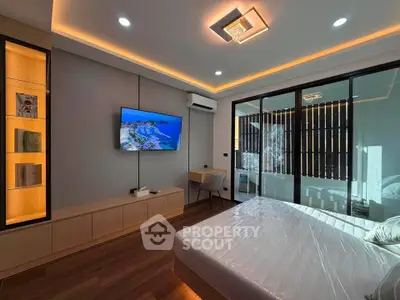 Modern bedroom with sleek design, built-in shelves, and large windows for natural light.