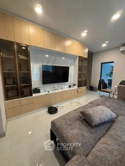 Modern bedroom with built-in entertainment center and sleek decor