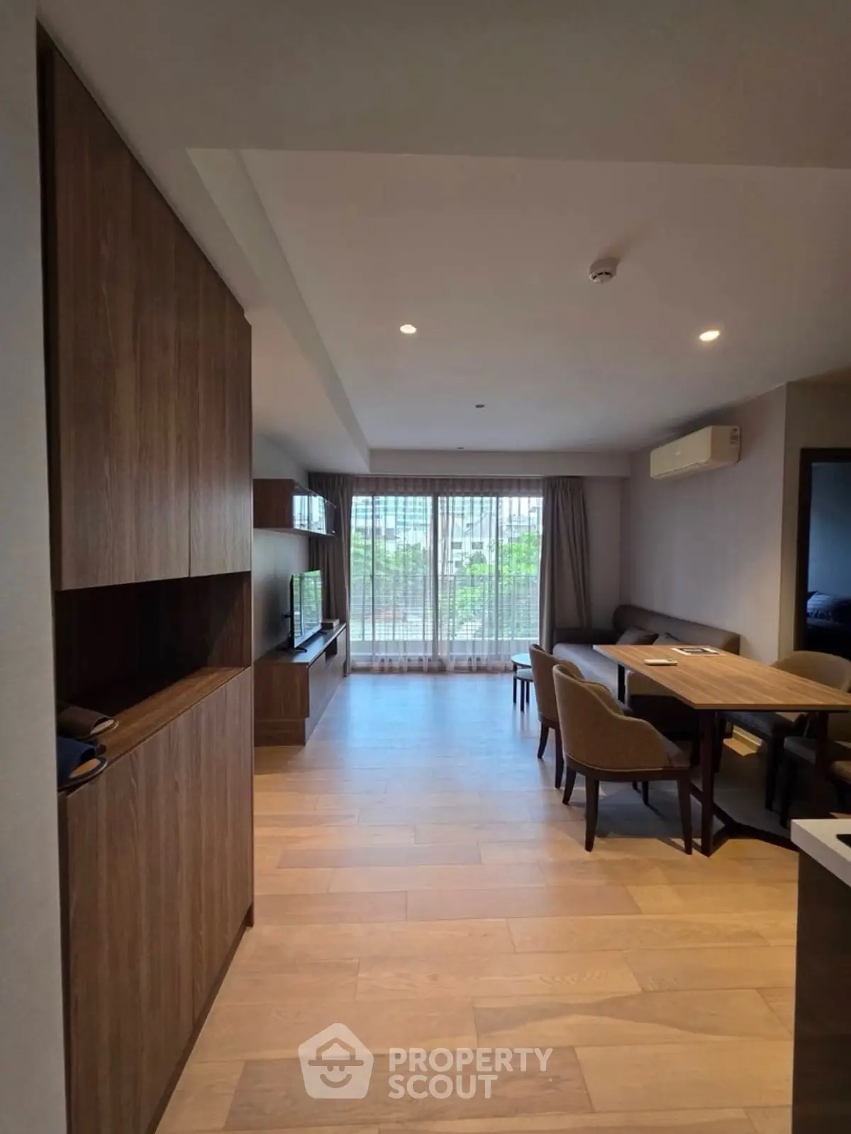 Spacious modern living room with dining area and large window view