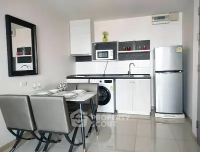 Modern compact kitchen with dining area, featuring washing machine and fridge.