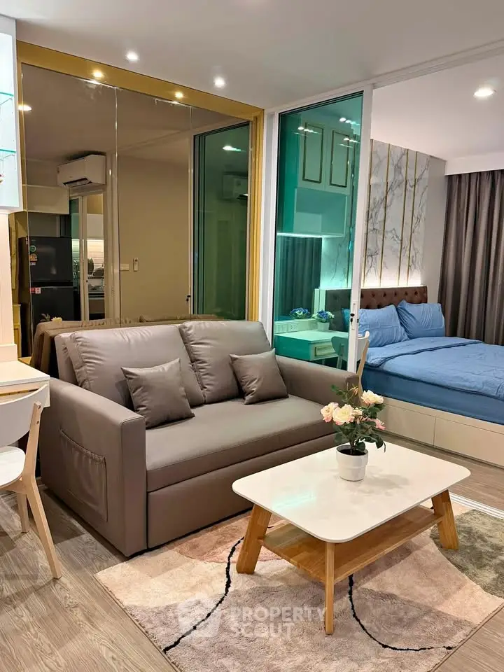 Modern studio apartment with cozy living area and stylish bedroom