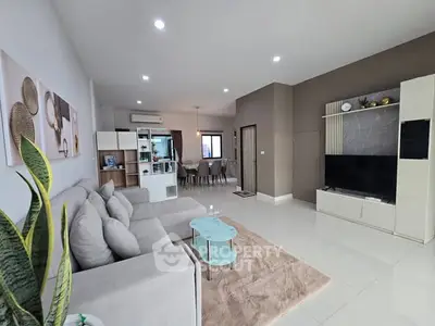 Spacious modern living room with stylish decor and open layout, perfect for family gatherings.