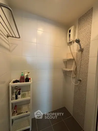 Modern bathroom with shower and storage shelves in a real estate property.
