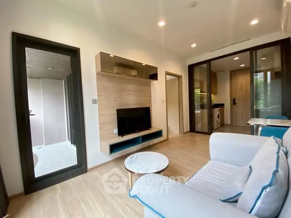 Modern living room with sleek furniture and open kitchen layout