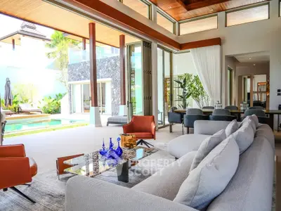 Luxurious open-plan living room with pool view, modern furniture, and elegant decor in a high-end property.