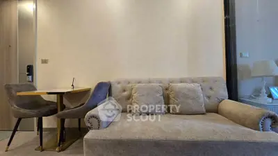 Modern living room with stylish sofa and dining area in a cozy apartment.