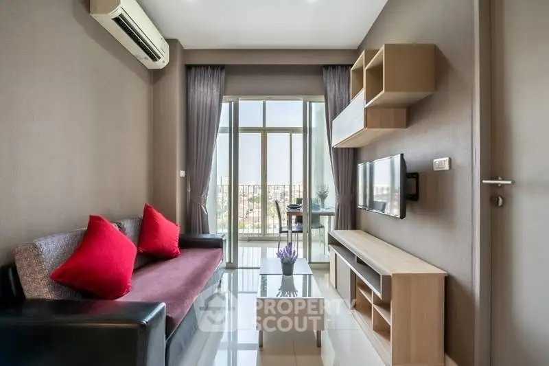 Modern living room with city view, featuring sleek furniture and large windows for natural light.