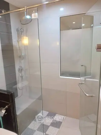 Modern bathroom with glass shower enclosure and sleek fixtures