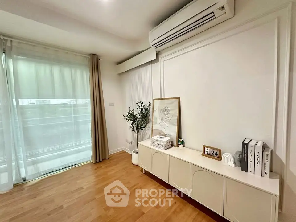 Stylish living room with modern decor and large window for natural light