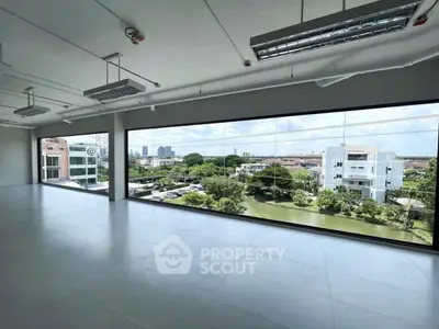 Spacious office space with large windows offering panoramic city views.