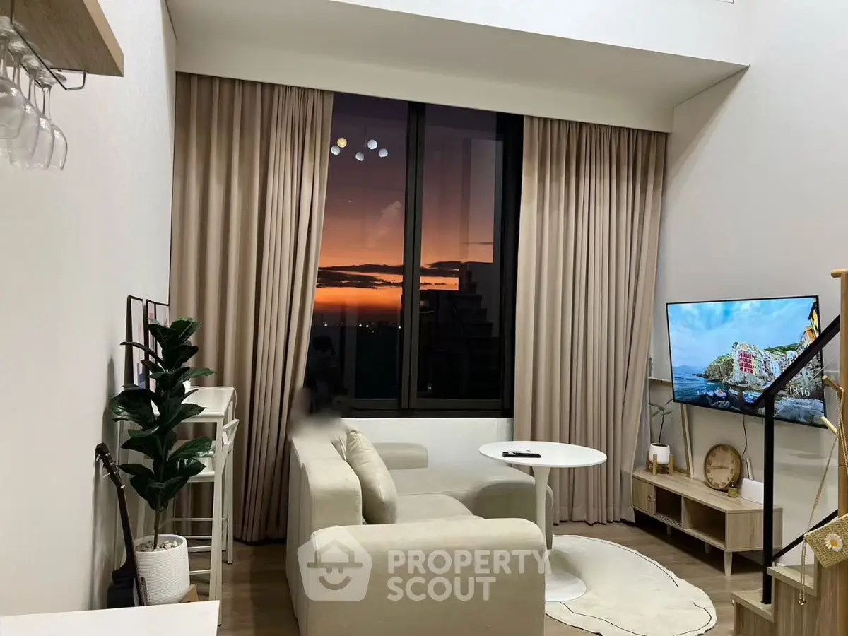 Modern living room with sunset view, cozy seating, and stylish decor