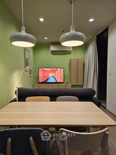 Modern living room with stylish lighting and wall-mounted TV, perfect for cozy gatherings.
