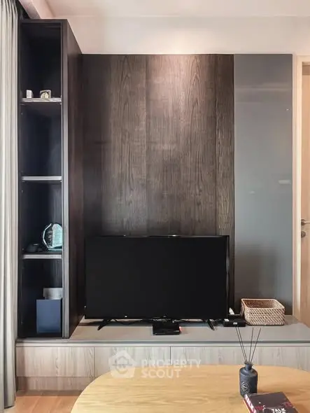 Modern living room with sleek TV setup and wooden accents