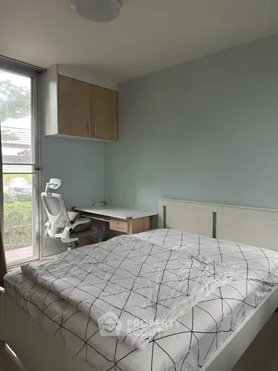 Cozy bedroom with modern furniture and natural light, perfect for a serene living experience.