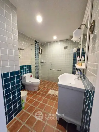 Charming bathroom with stylish tiles and modern fixtures, perfect for a cozy home.