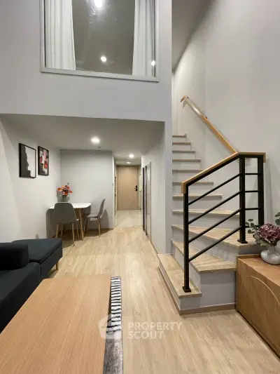 Modern duplex interior with stylish staircase and cozy dining area