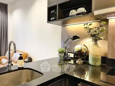 Modern kitchen with sleek black countertops and stylish decor accents