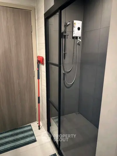 Modern bathroom with sleek shower enclosure and stylish fixtures.