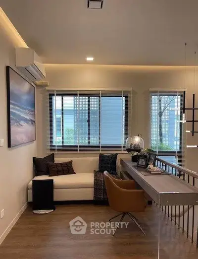 Stylish modern living room with cozy seating and large windows offering natural light.