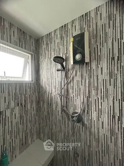 Modern bathroom with stylish tile design and shower unit