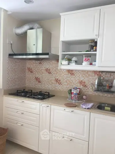 Charming kitchen with gas stove and stylish cabinetry, perfect for culinary enthusiasts.