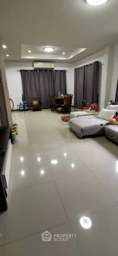 Spacious living room with modern decor and ample natural light