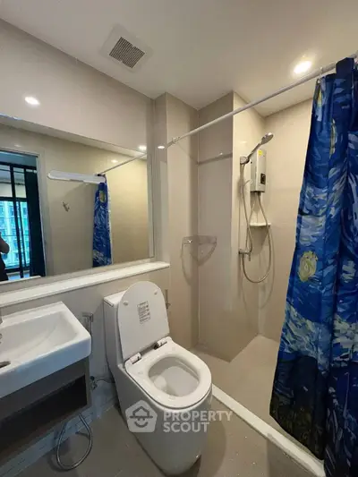 Modern bathroom with shower and toilet in sleek apartment