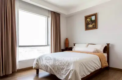 Cozy bedroom with large window and elegant decor