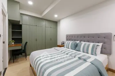 Cozy bedroom with stylish decor and built-in storage, perfect for modern living.