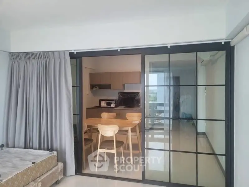 Modern open-plan kitchen with dining area and sliding glass doors