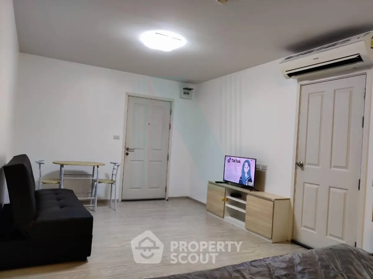 Modern living room with sleek furniture and air conditioning, ideal for comfortable urban living.
