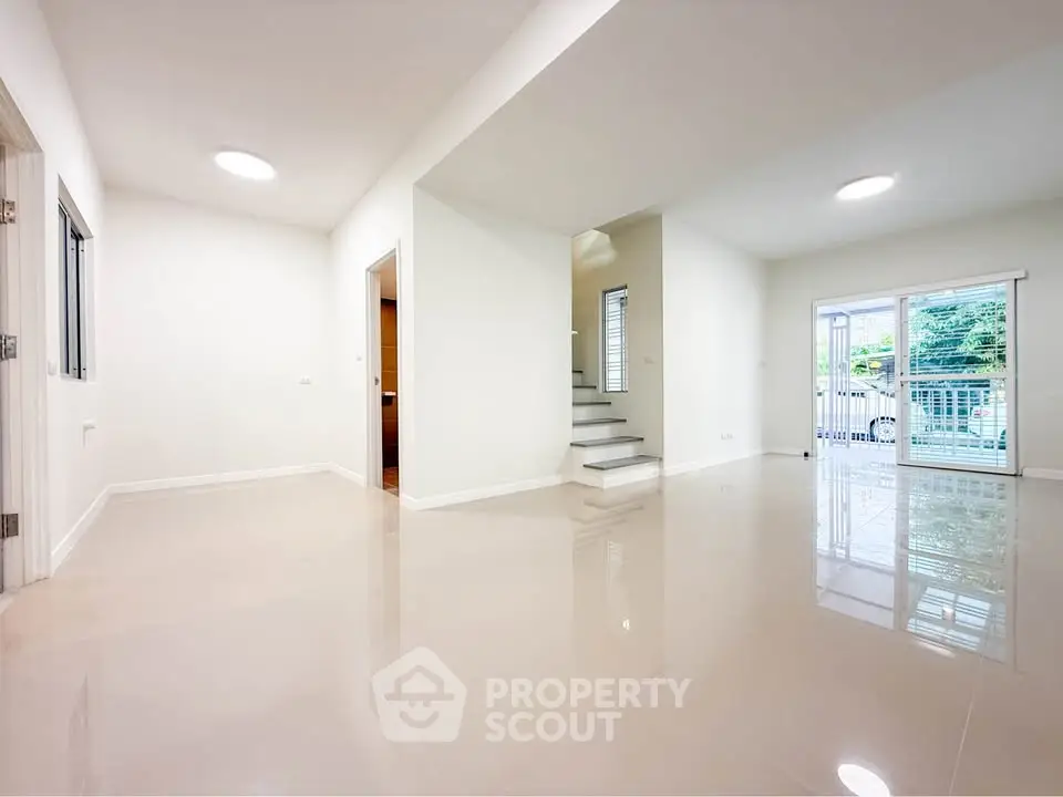 Spacious modern living room with glossy floors and natural light