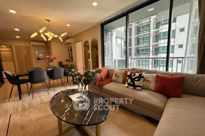 Modern living room with stylish decor and large windows in urban apartment