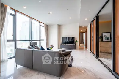 Luxurious modern living room with city view and sleek furnishings.