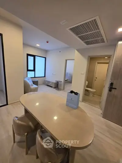 Modern apartment interior with open living area and stylish furniture, showcasing a cozy and inviting atmosphere.