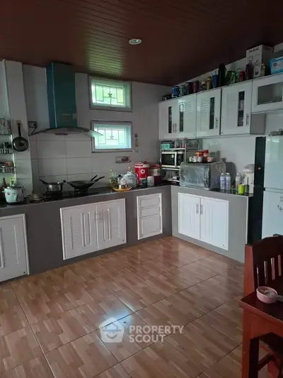 Spacious kitchen with modern appliances and ample storage space.