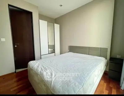 Cozy bedroom with modern furnishings and ample natural light.